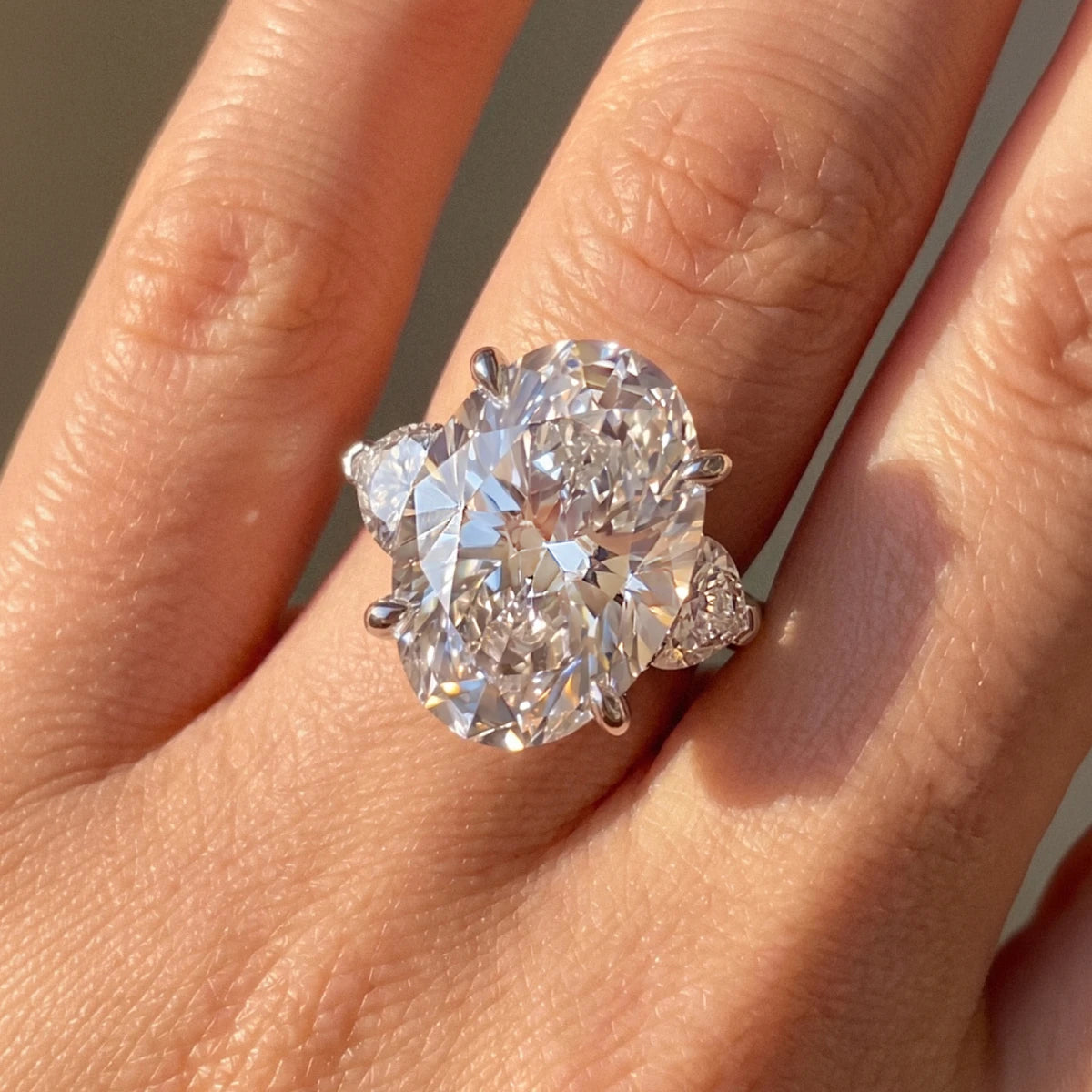 Oval Diamond Ring with Heart Side Stones | Earthly Jewels | Model Image