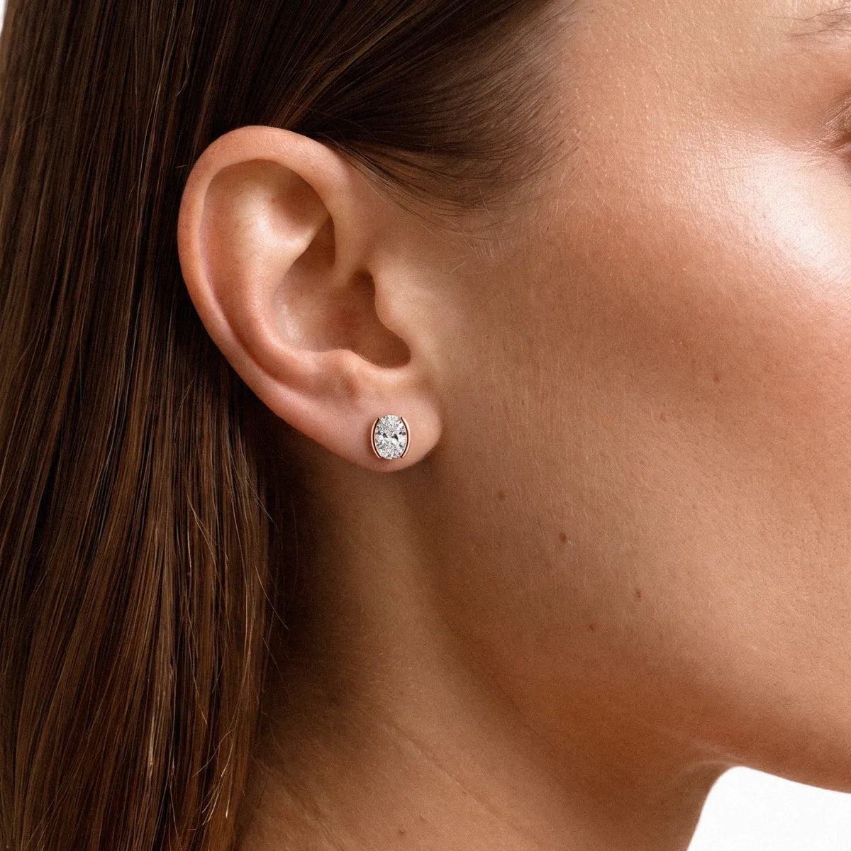 Oval Cut Diamond Stud Earrings with Half Bezel Setting | Model Image