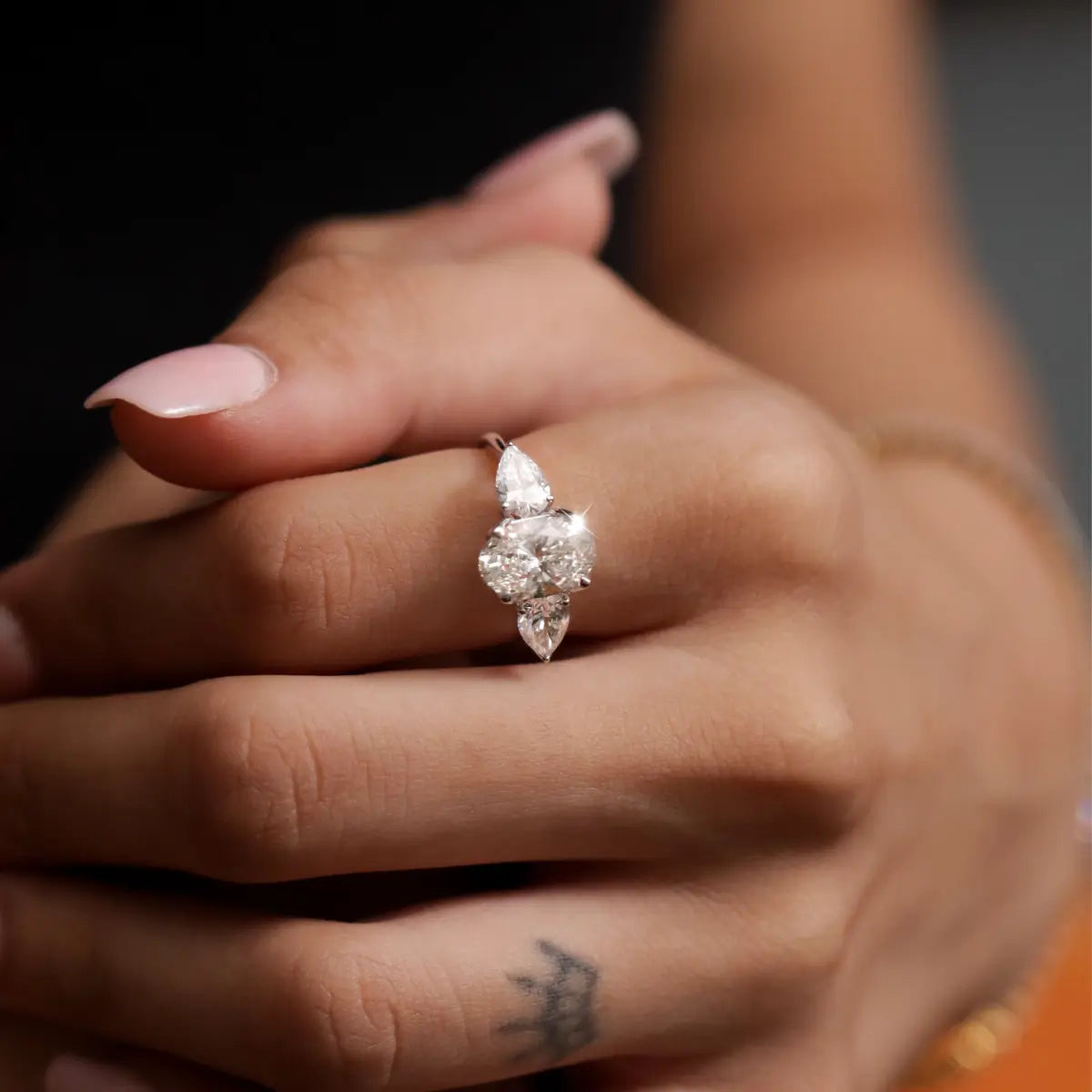 Oval Diamond Triology Ring In Floral Setting With Side Pear