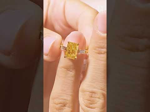 Load video: Yellow Radiant Solitaire Engagement Ring With Tapered Baguette | Earthly Jewels