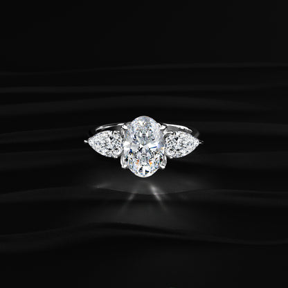 Oval Diamond Triology Ring In Floral Setting With Side Pear