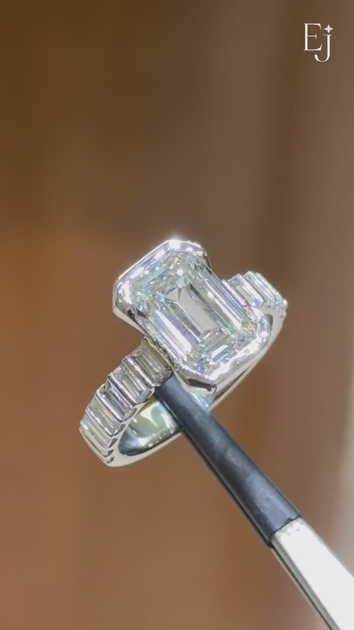 Load video: Emerald Diamond Half Bezel Ring with Side Baguette Stones | Video